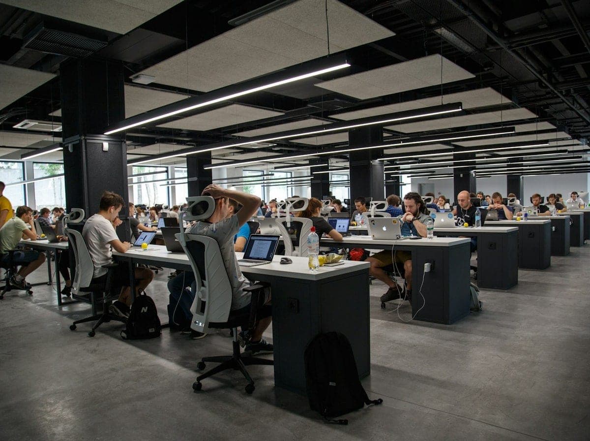 Senior software engineering team collaborating at modern workstations for Arkansas technology initiatives