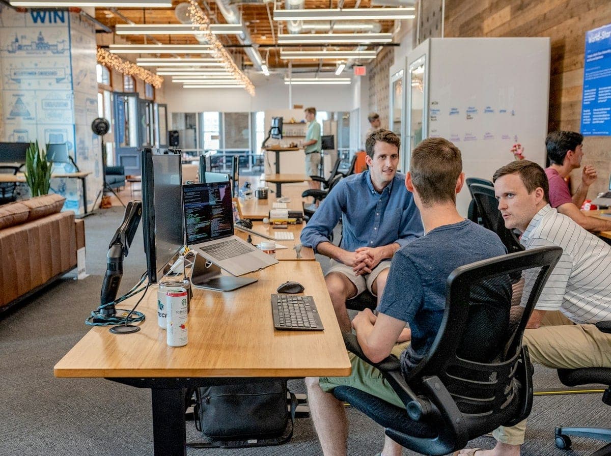 Senior software engineering team collaborating at modern workstations for North Dakota technology initiatives